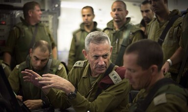 Men in military uniforms confer