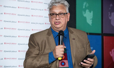 A man holding a microphone and a cell phone