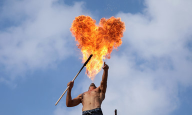 Heart-shaped cloud of fire hangs over a shirtless man 