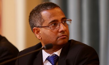 Close up of man seated in front of microphone