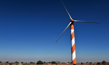 A wind turbine on top of open land