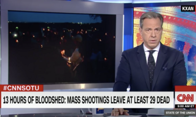 Man in suit reads news on TV