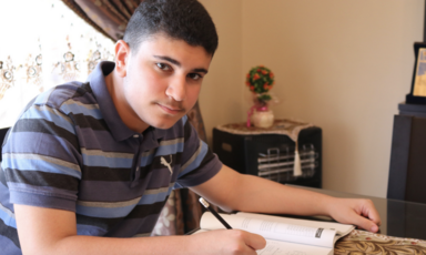A teenager writes in a book