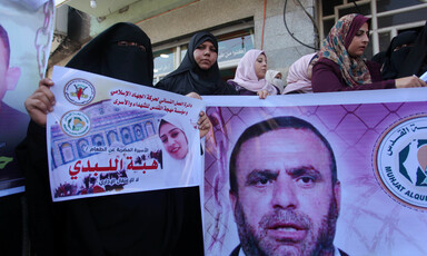 People hold banners