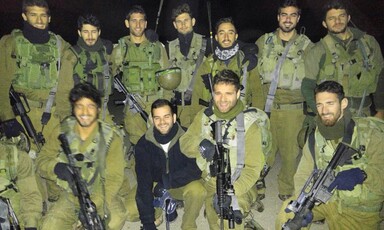 Men in uniforms hold rifles