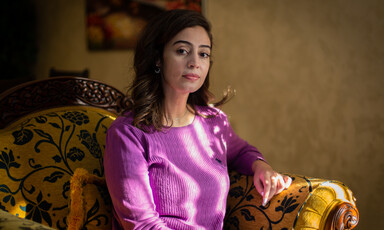 Woman sits on a cushioned chair