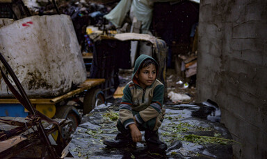 Child sits on a wet surface