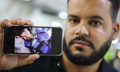 Man holds cellphone with a photograph on it 