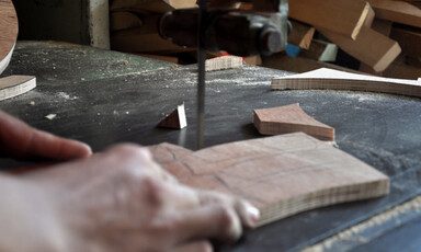 A hand holds a piece of wood