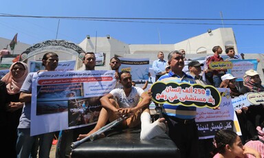 People hold a variety of placards 