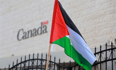 Palestinian flag flies in front of building marked Canada