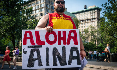 Man holds placard 