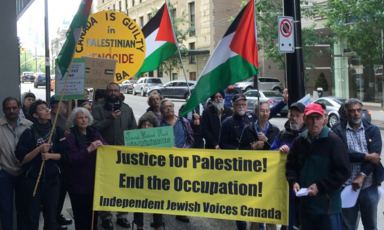 Vancouver demonstrators wave Palestinian flags and hold signs