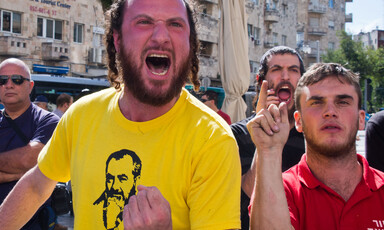 Close up of men as one shouts angrily