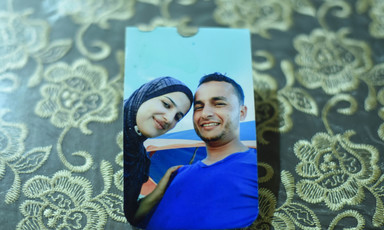 A color photo of a smiling couple lies on a table