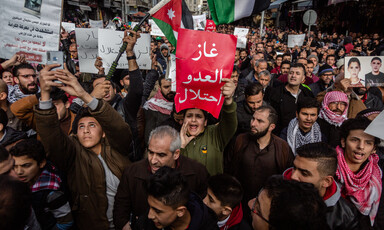 Hundreds of protesters hold banners, flags 