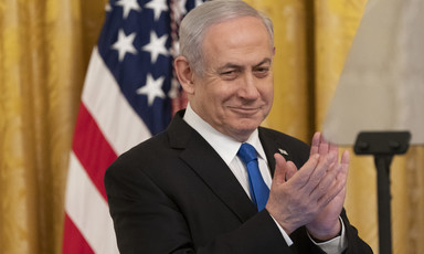 Benjamin Netanyahu smiles and claps his hands