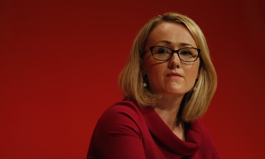 A woman with glasses and a red outfit