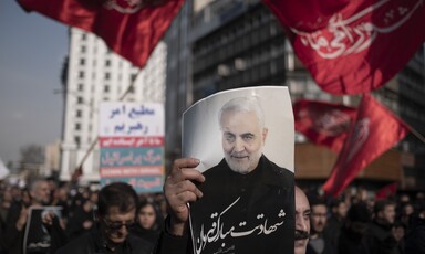 People demonstrate with flags and posters