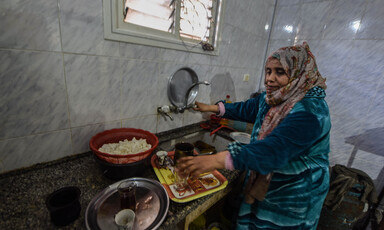 A woman near her kitchen sink