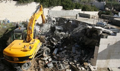 Bulldozer destroys a building