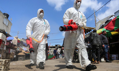 Medical workers disinfecting market 