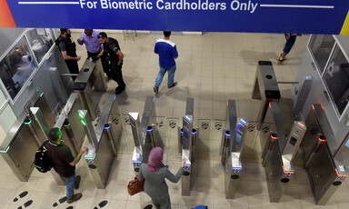 People pass through electronic gates