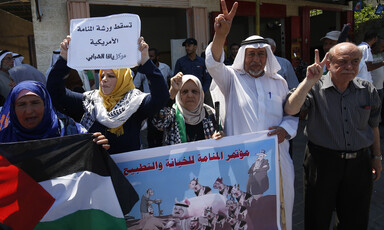 People hold up banners during a demonstration