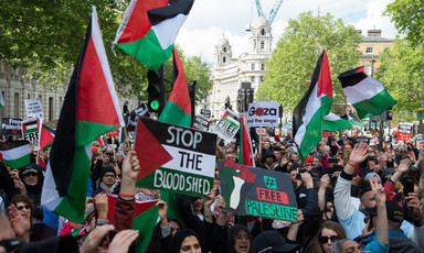 A crowd of people with Palestinian flags
