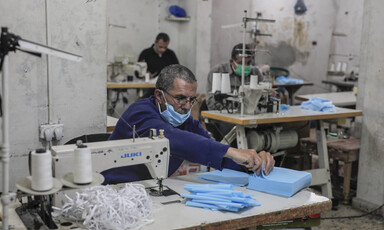 Men sewing protective face masks