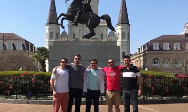 Five men stand in front of statue of Andrew Jackson on horseback