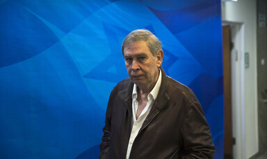 Man stands in front of a display showing a large star 