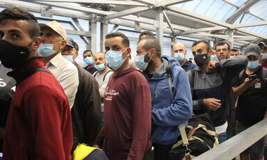 Men wearing surgical masks in queue 
