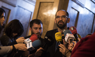 Man surrounded by microphones
