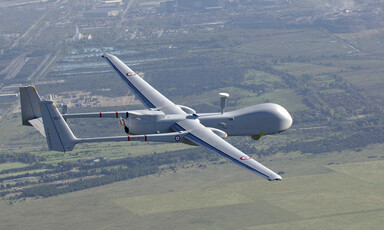 Drone suspended over land