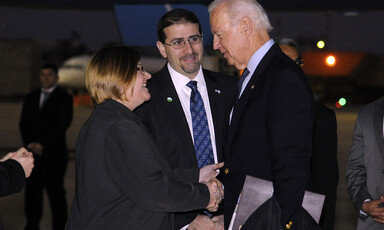 Three people talking at airport