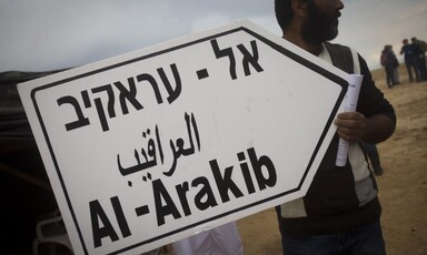 Man holds sign 