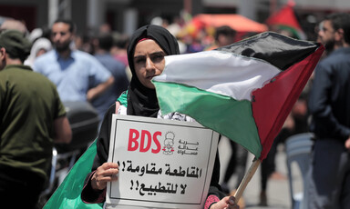 A woman holds a sign