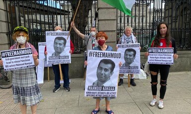 People hold signs and flags