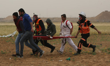 Medics rush an injured demonstrator to safety