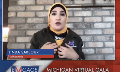 Woman gestures and speaks to camera