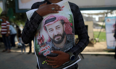 A man embraces a poster of a man