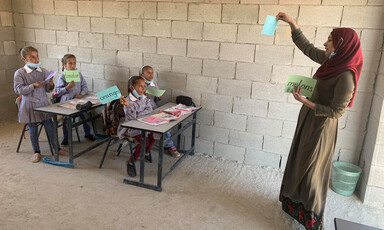 Teacher gives lesson to young students