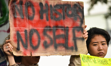 A protester holds a sign