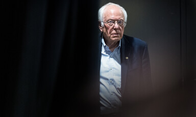 Man emerges from behind a curtain