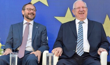 Two men sit in adjacent chairs