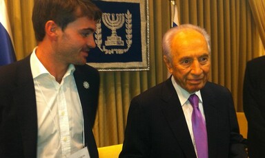 Man stands beside other man