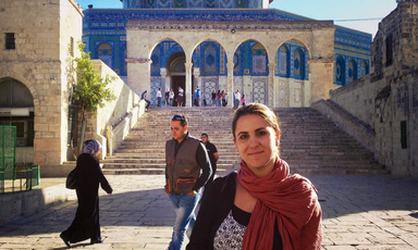 Woman stands outside the Dome of the Rock