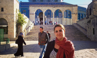 Woman stands outside the Dome of the Rock