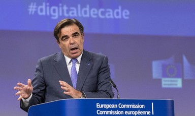 Margaritis Schinas stands at podium marked "European Commission" 